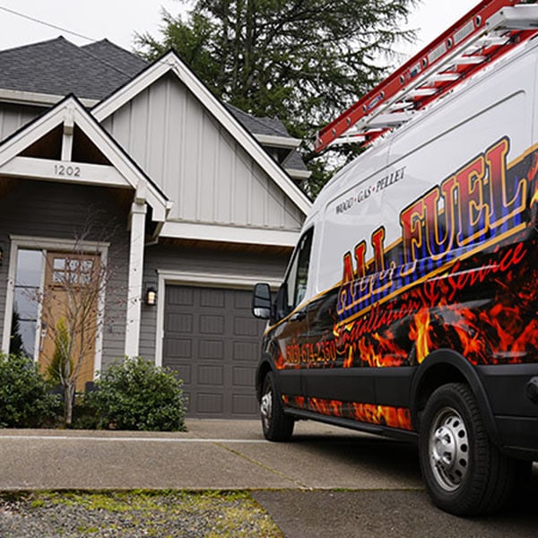 All Fuel work vehicle parked in front of a home.