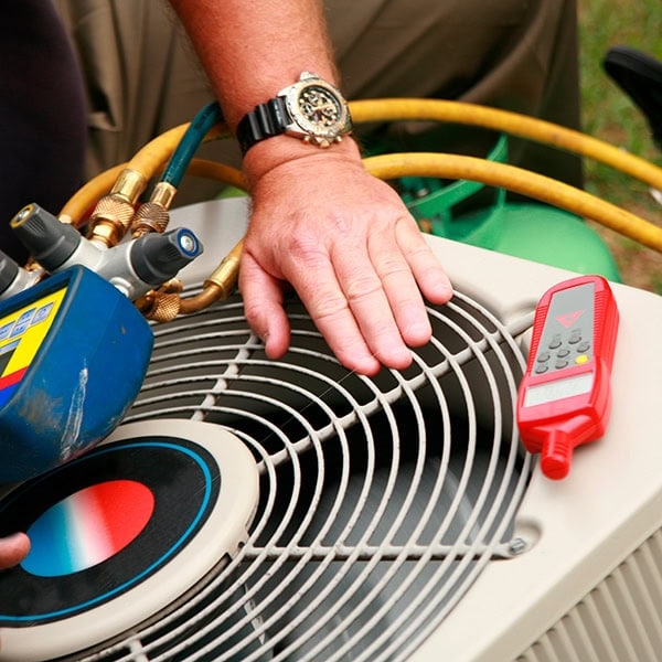 HVAC technician walking up a homes driveway.