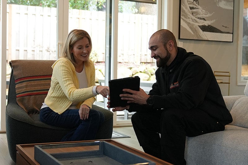 All Fuel technician and customer looking at tablet.