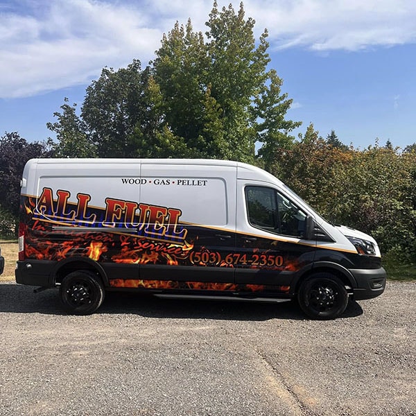 All Fuel work van park in the street by trees.