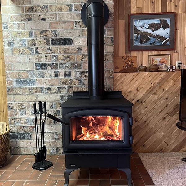 A lit fireplace installed in a home.