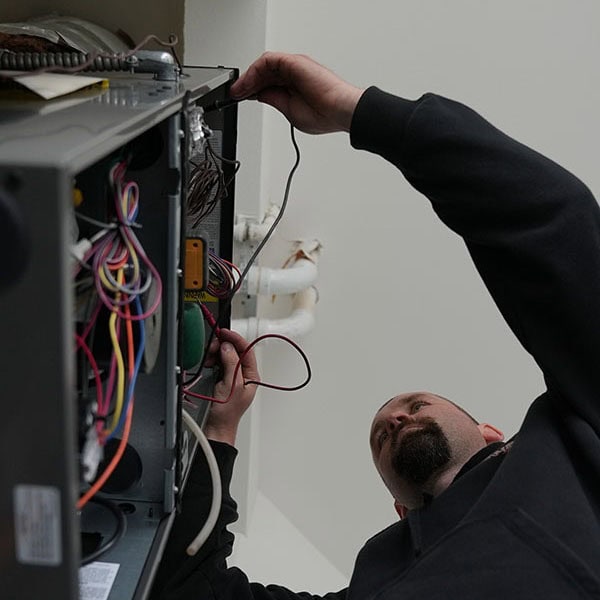 Technician working on repairing an HVAC system.