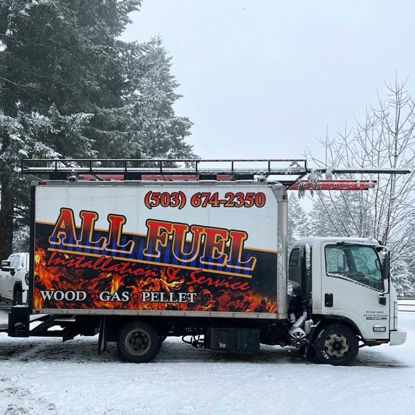 All Fuel work truck parked in a snowy driveway.