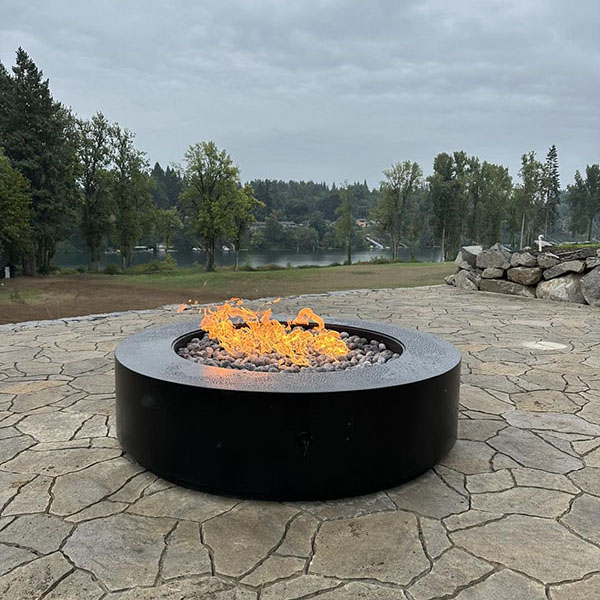 A newly installed gas fireplace outside a home.