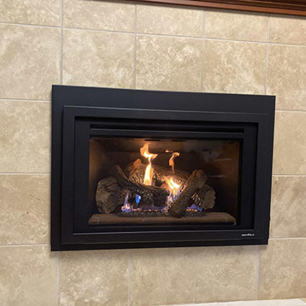 A newly installed gas fireplace outside a home.
