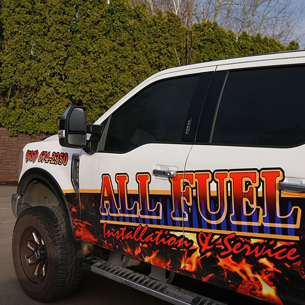 Close up of a parked All Fuel work vehicle.