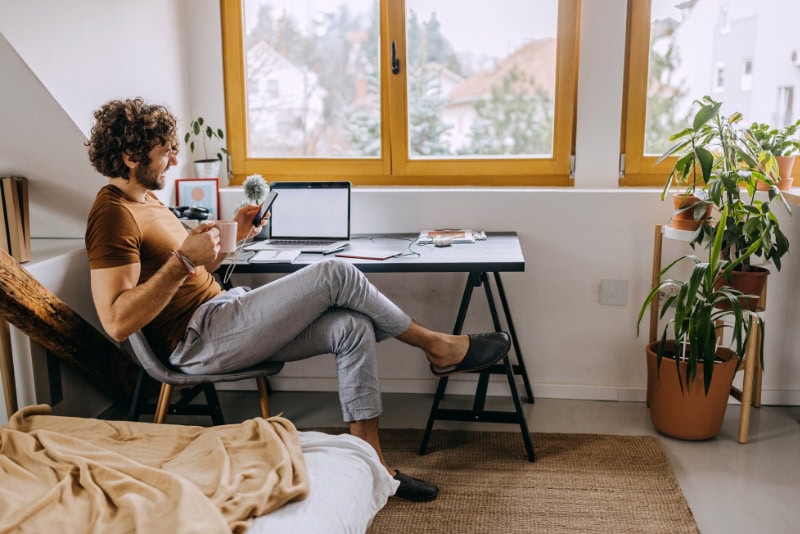 Man working in office enjoying indoor heat thanks to buying a heat pump for his Gresham, OR, home.