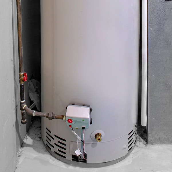 A tank water heater in a garage of a home.
